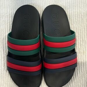 Gucci women's slides. All rubber with both two tone Gucci stripes!